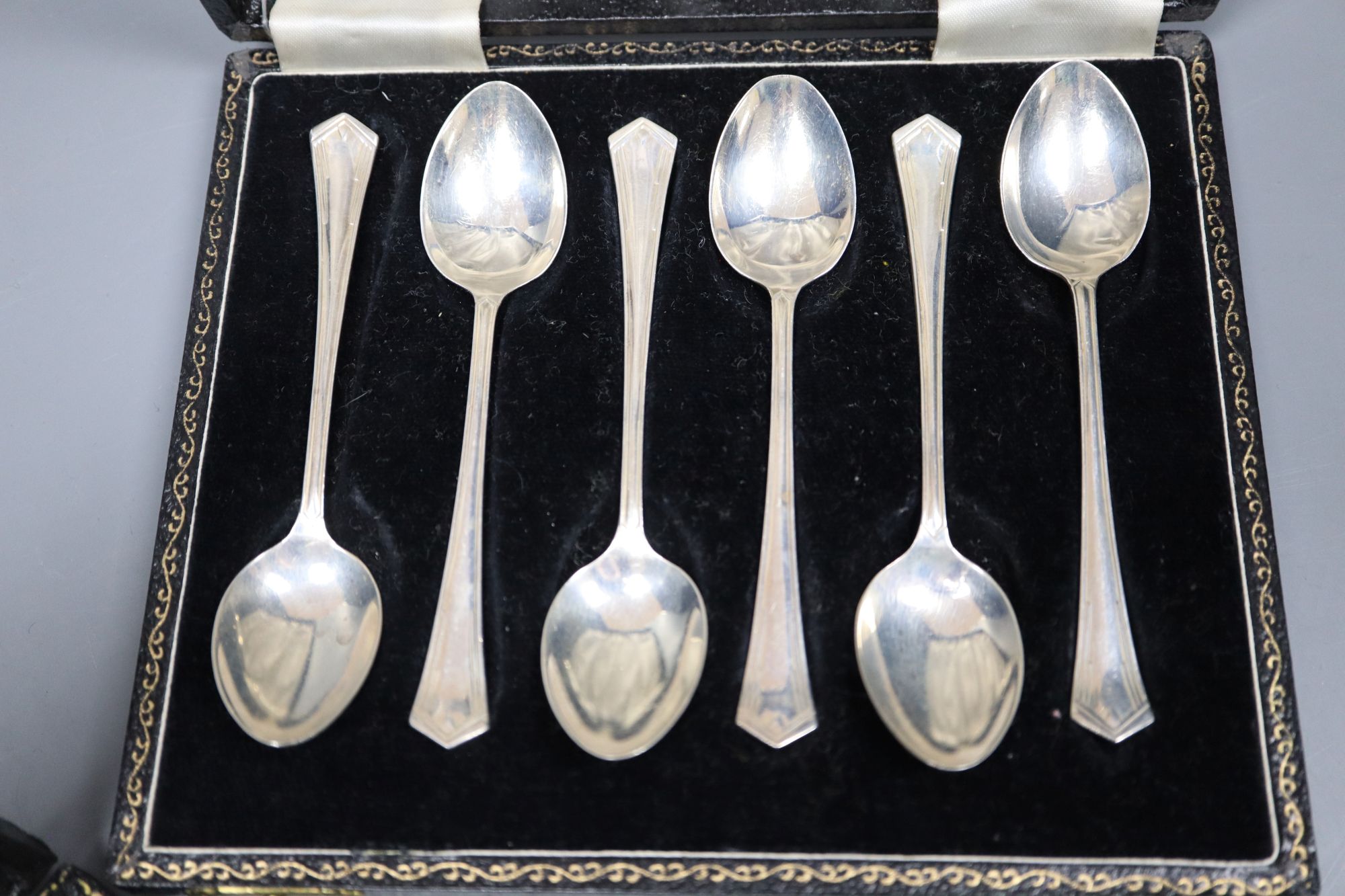 A cased set of six mid 20th century silver teaspoons and six similar coffee spoons.